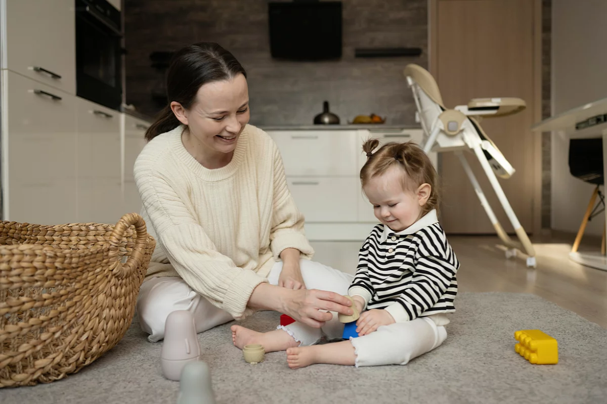 Mother and child playing with pieces of lego