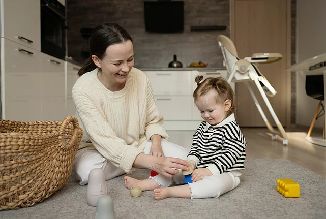 Mother and child playing with pieces of lego