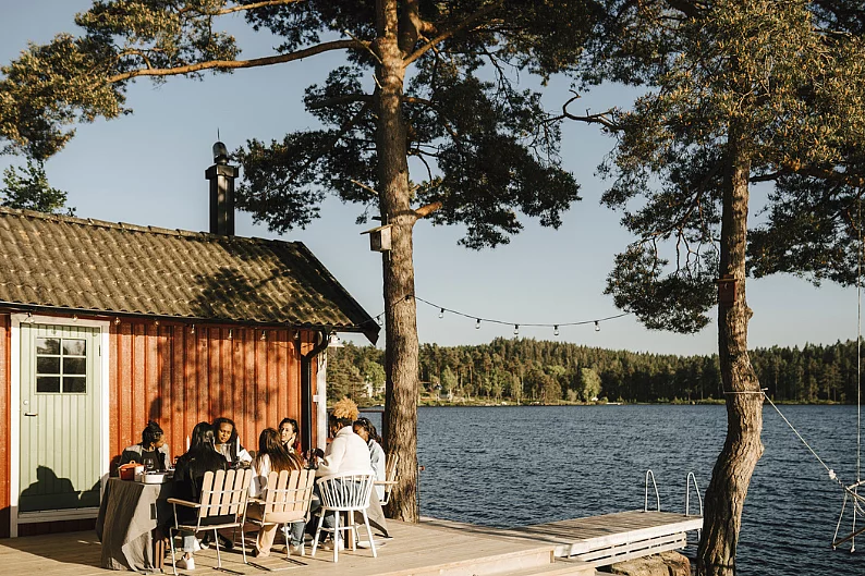 Female friends having dinner at back yard on sunny day
